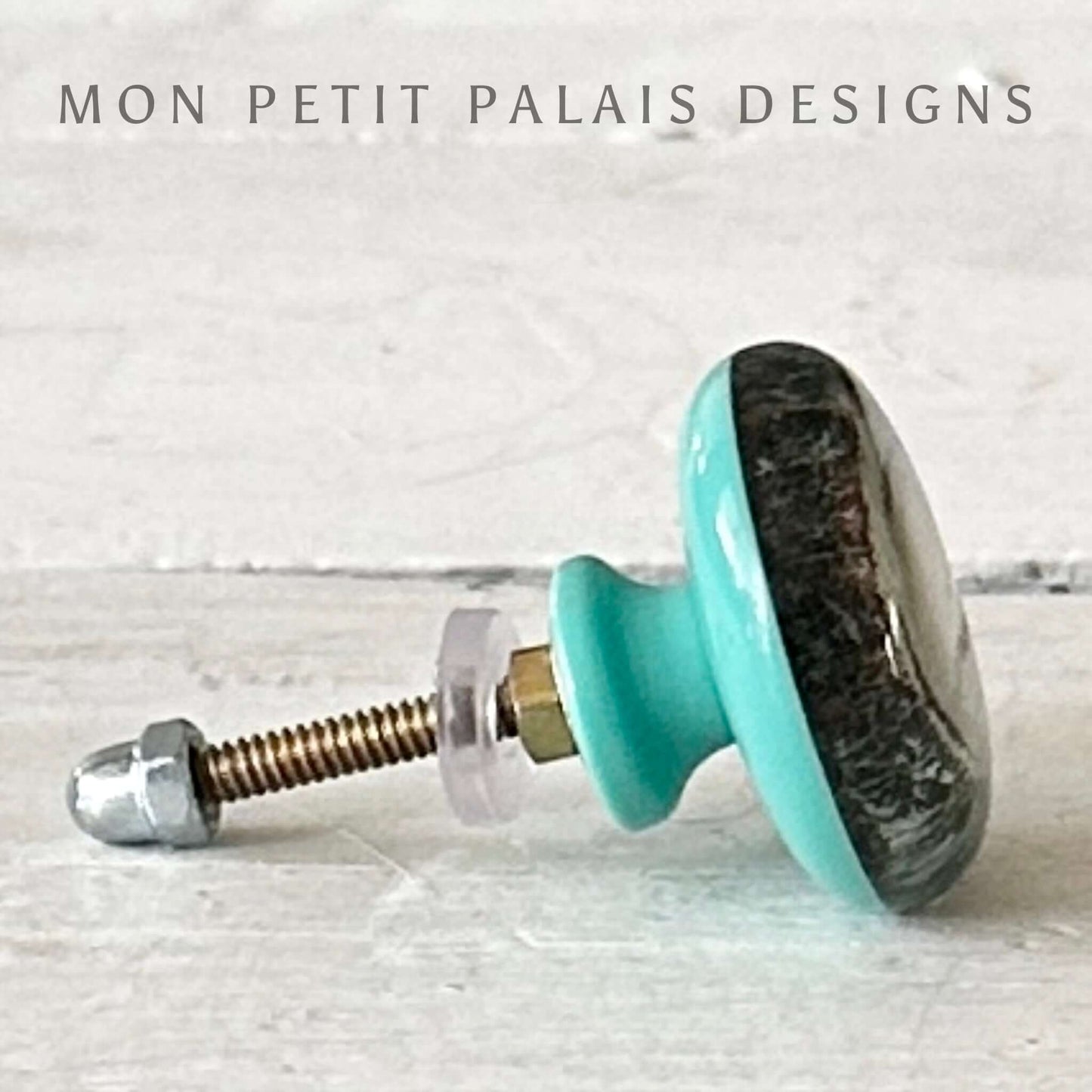Turquoise resin cabinet knob with metal hardware on a light gray background, featuring 'Mon Petit Palais Designs' branding.