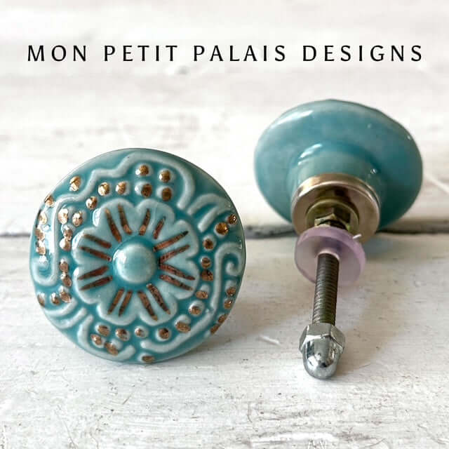 Pair of Seafoam Green Embossed Ceramic Cabinet Knobs with intricate raised floral detailing and antique gold highlights, perfect for coastal and vintage furniture.