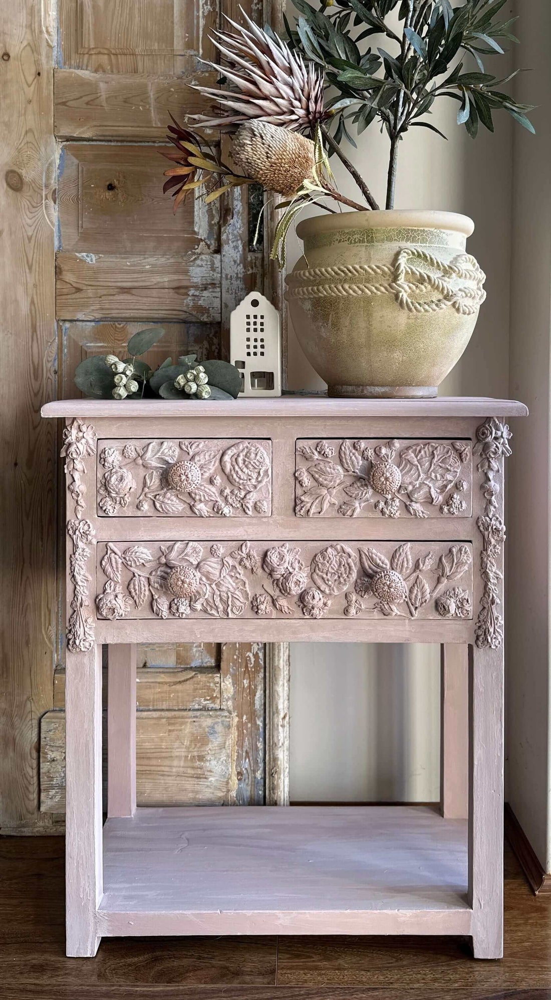 Elegant side table painted in Annie Sloan's Jaipur Pink & Rococo Whtie, featuring intricate floral carvings.