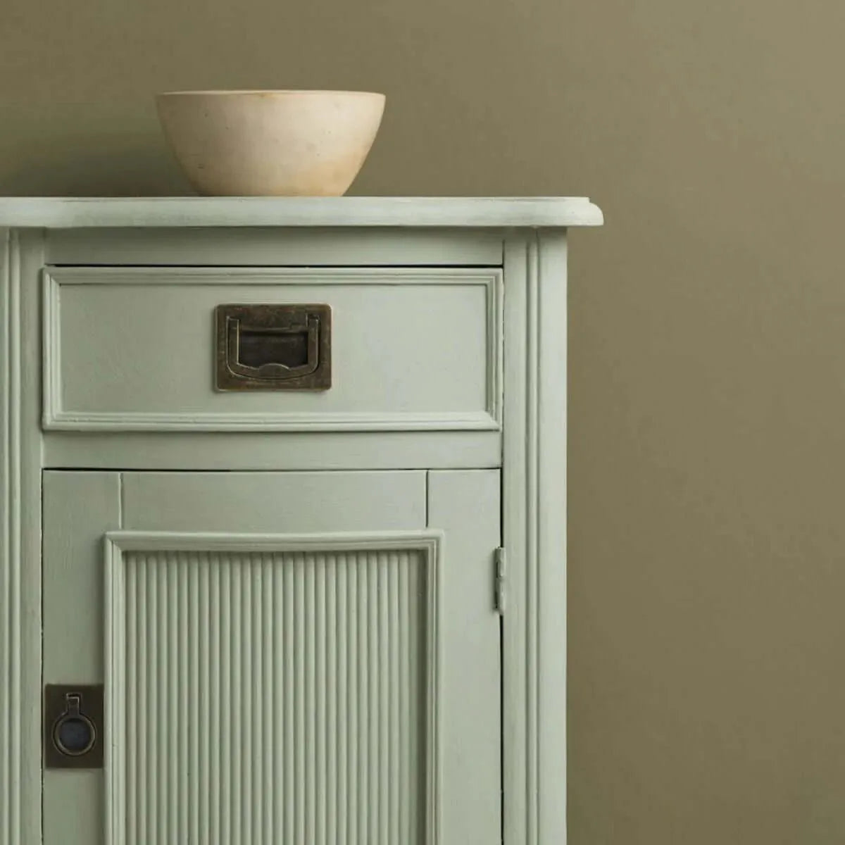 Annie Sloan Chalk Paint® on a vintage mint-green cabinet with a ceramic bowl on top.