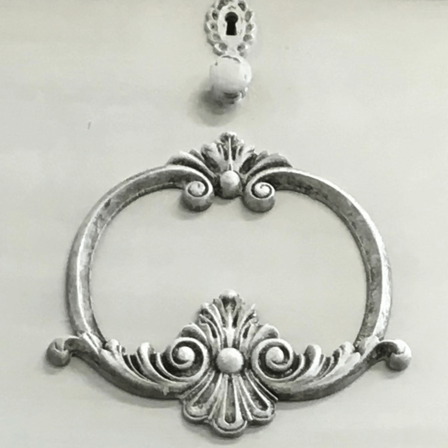 Ornate scrollwork applique painted and waxed on dresser front