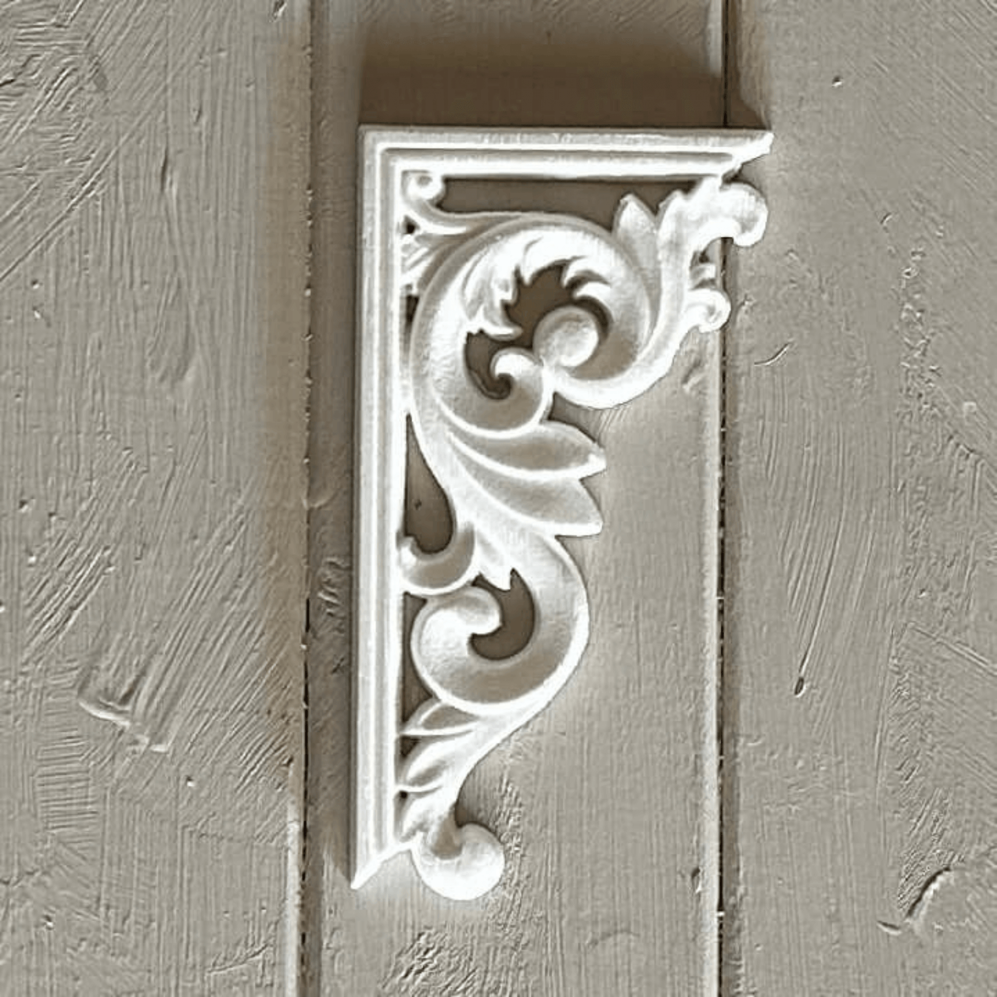 Classic white furniture appliqué with symmetrical scrollwork, designed for enhancing drawer fronts, sideboards, and vintage-inspired décor projects.