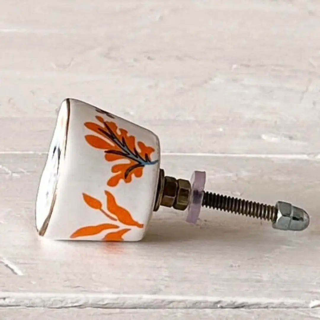Orange & Blue Floral Hand-Painted Ceramic Knob showcasing vibrant orange and blue floral design on a stylish furniture knob.