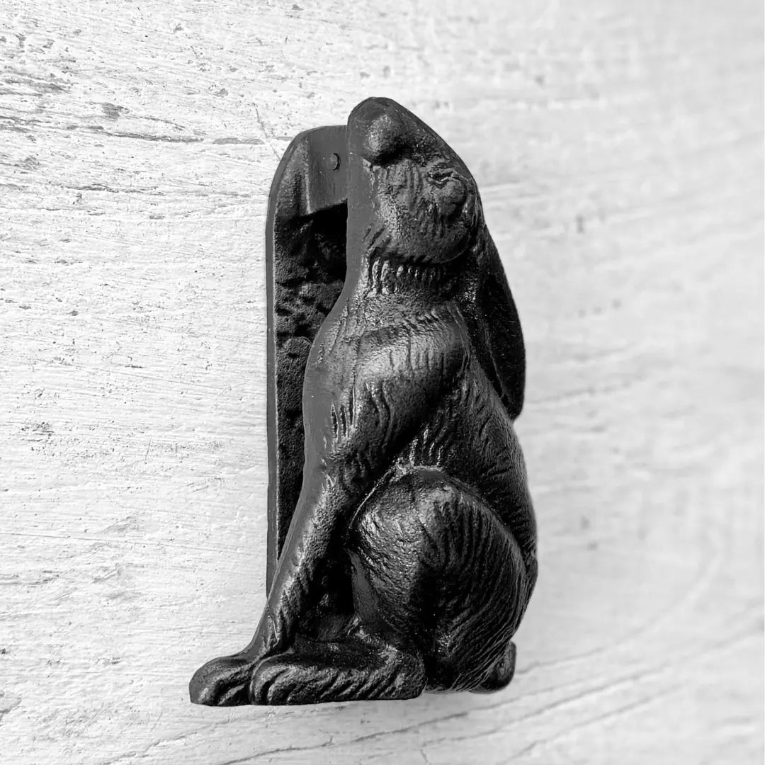 Side profile of the Lapin Classic French Rabbit Door Knocker in aged bronze cast iron, highlighting the sculpted rabbit detail and sturdy mounting bracket.