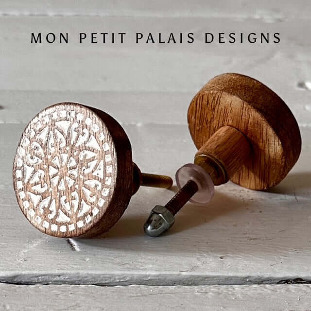 Pair of Marie carved wood knobs showing side and front view - relaxed boho styling with warm wood tones.