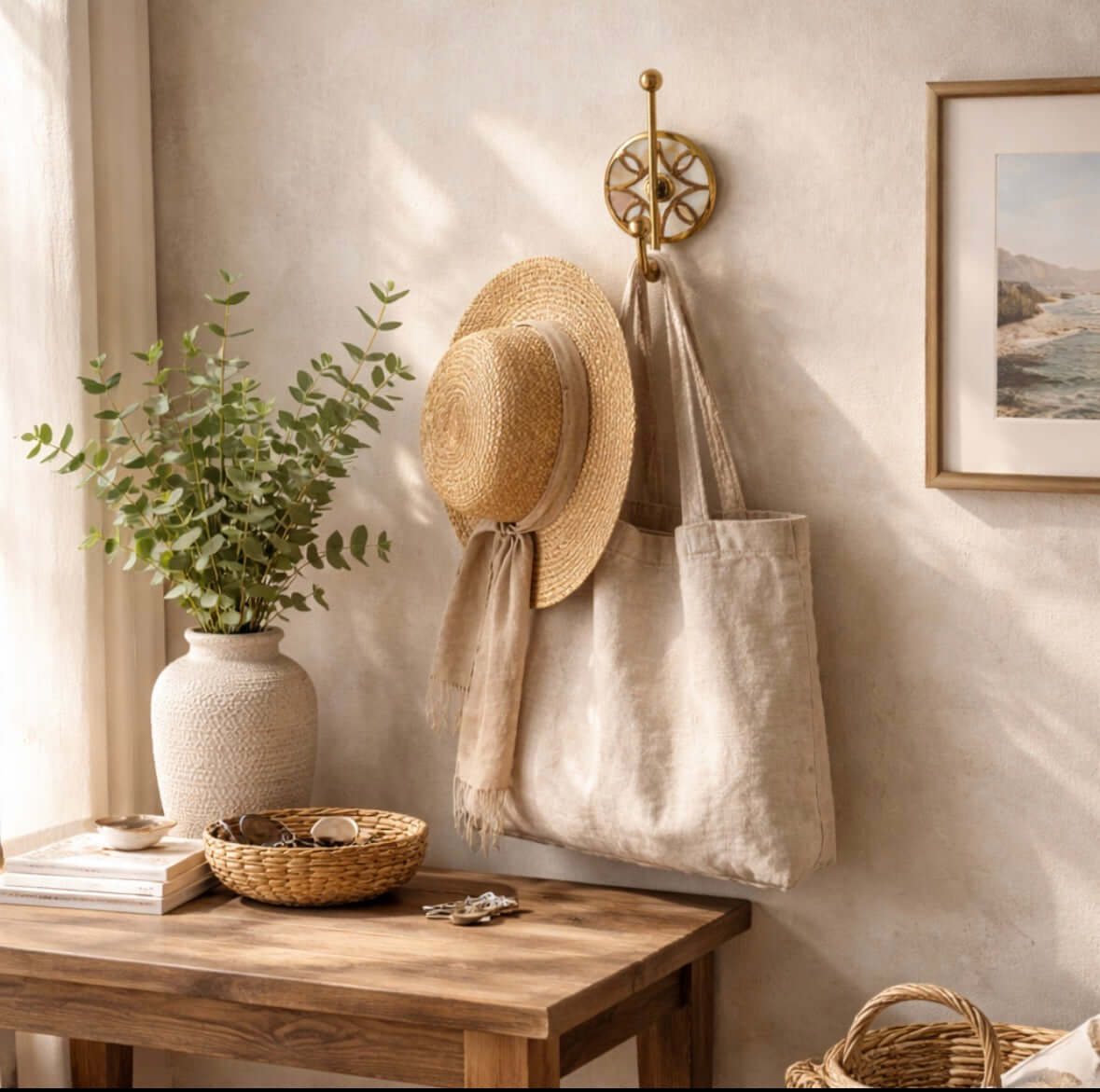 Mother of Pearl Wall Hook holding a straw hat and a tote bag, with a plant and decorative items on a wooden table.