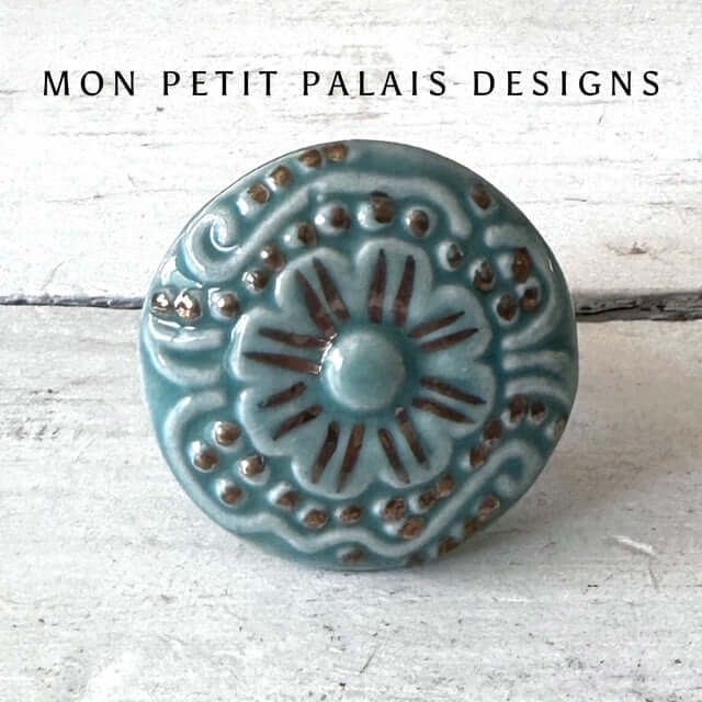 Seafoam Green Embossed Ceramic Cabinet Knob with raised floral detailing, gold highlights, and a vintage-inspired glaze for furniture and cabinetry.