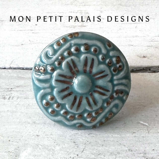 Seafoam Green Embossed Ceramic Cabinet Knob with raised floral detailing, gold highlights, and a vintage-inspired glaze for furniture and cabinetry.