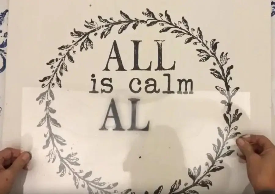 IOD Thin Mount being used to apply a floral stamp design with the words 'ALL is calm AL' for crafting.