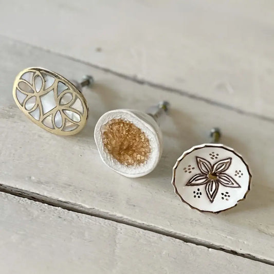 toffee and white ceramic knob with glass face styled with a trio of decorative knobs