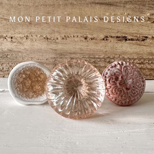 Rose Quartz Pink Glass Knob with set of three vintage-style furniture knobs, including a white ceramic knob with amber detail and a Henrietta Rose ceramic knob with a floral pattern. Ideal for furniture upcycling and home decor projects.
