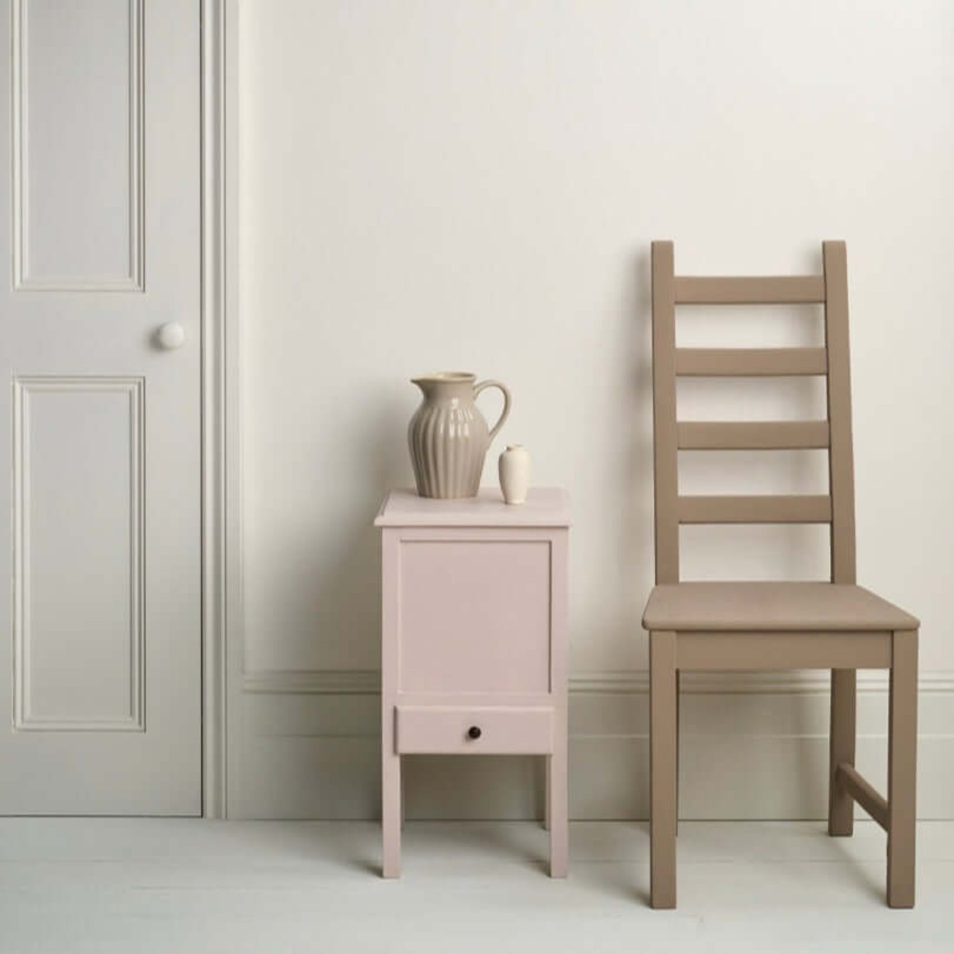 Pure - Annie Sloan Satin Paint used on a bedside table and chair in a minimalist interior setting.