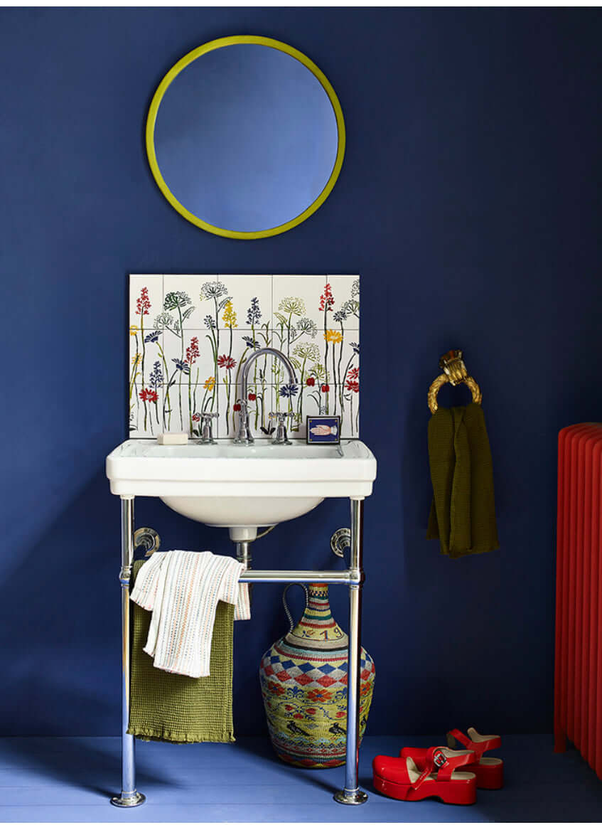 Napoleonic Blue - Annie Sloan Wall Paint in a stylish bathroom setting with colorful decor and round mirror.